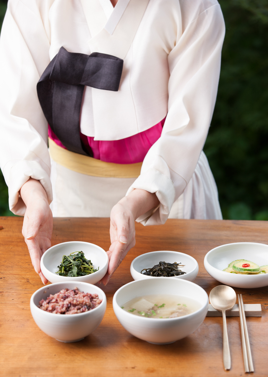 Small dishes, soup, and utensils arranged at a hanjeongsik table setting