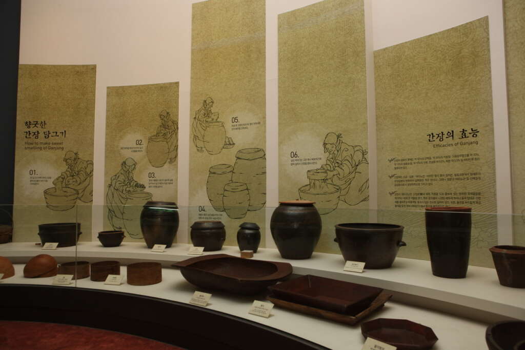 Illustrated fermentation-history panels and earthenware jars inside Sunchang Jangryu Museum